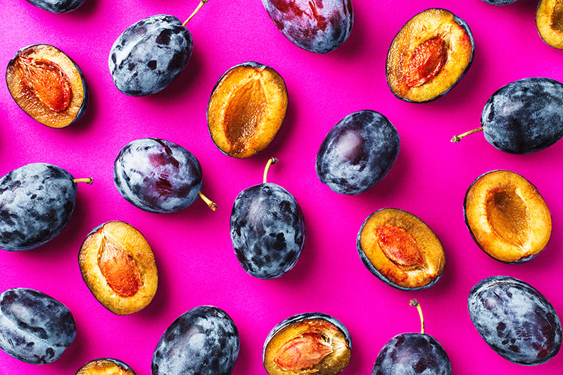 Plums in a pattern on a purple background